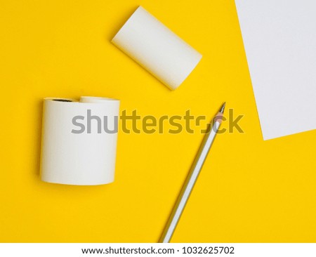 Minimalistic background for copy space, white sheet of paper. Pencil on a yellow background.
