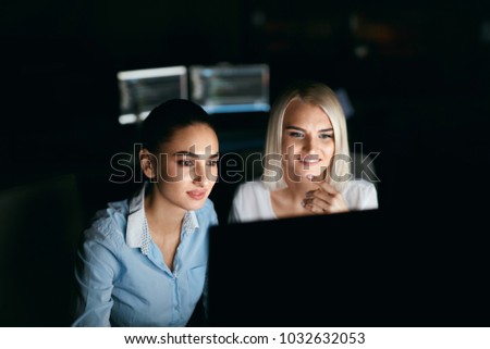 Young Women Working And Programming On Computer In Office. Beautiful Females Programmer Working Looking At Monitor, Typing Data Code In Company Office In Evening. High Quality Image.