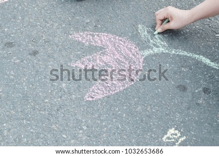 Hand is painting on the street.
