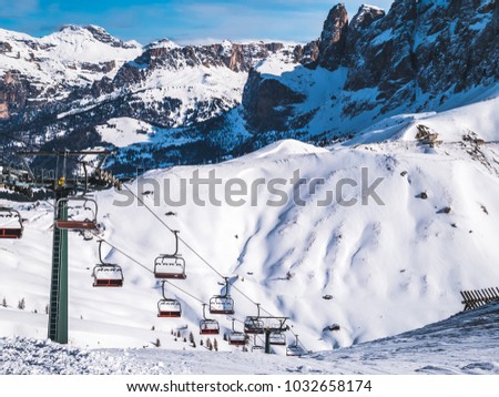 Steep chair lift in the ski slope. Canazei, Alps, Italy.