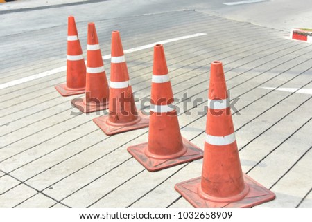 The cone divides the traffic lane.