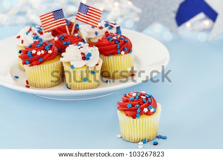 American patriotic themed cupcakes for the Fourth of July. Shallow depth of field with selective focus on cupcake in foreground.