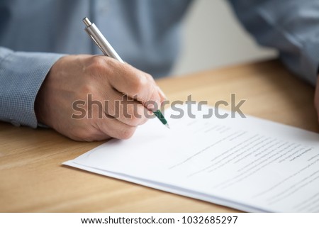 Older male hand signing business document, senior man putting signature on legal paper making investment, elderly aged businessman taking bank loan or insurance, writing will testament, close up view Royalty-Free Stock Photo #1032685297