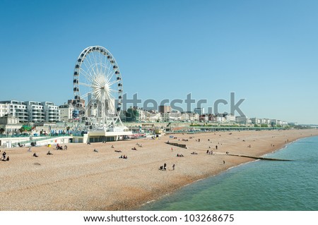 Clear blue sky over Brighton beach, UK and the tourist attractions of Madeira Drive Royalty-Free Stock Photo #103268675