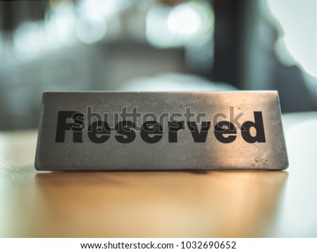 Cinematic style. Reserved sign on top of a wooden table in a restaurant, Reservation seat at restaurant for dating on celebrate day concept.
