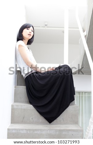 asian woman sitting on the stair