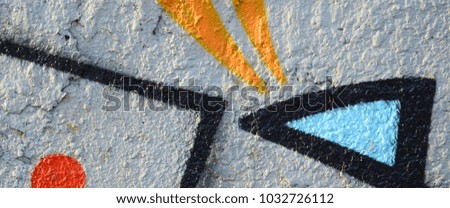 The old wall, painted in color graffiti drawing blue aerosol paints. Background image on the theme of drawing graffiti and street art