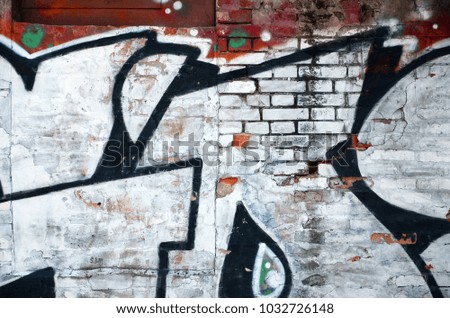 The old wall, painted in color graffiti drawing red aerosol paints. Background image on the theme of drawing graffiti and street art