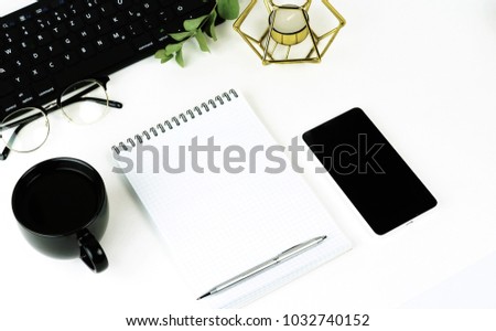 Top view of white office table with laptop, smartphone, cup of coffee and supplies. Top view with copy space. Flat lay.