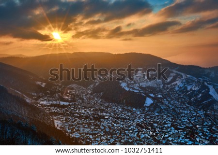 The city Brasov at sunset above the Mount Tampa in the winter time