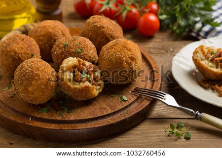 Classic, Italian arancini. Rice balls with minced meat. Front view. Royalty-Free Stock Photo #1032760456