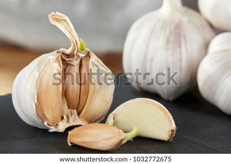 Garlic close up on wooden plate on black board,shallow depth of field, selective focus, macro