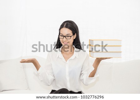 Beautiful Attractive Asian woman smile sitting on sofa and holding book feeling so happiness and cheerful,Education Concept
