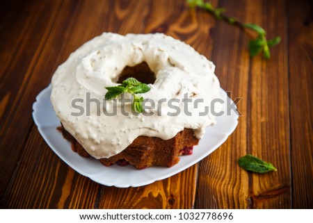 large sweet honey cake with cream on a wooden table
