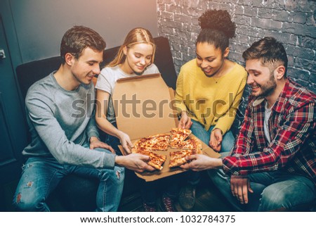 Group picture of students where everybody is holding a peace of pizza. They are so hungry that they can't wait anymore and want to eat it right now. Party night