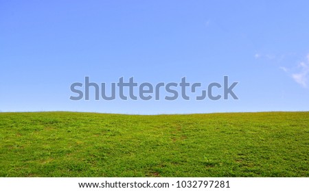 beautiful Green lawn with  clear blue sky  day light in national park hill during rainy seasons. Ecotourism journey travel and Global warming background wallpaper concept. (wide screen )