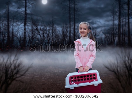 Happy little girl with pink carrier in the forest