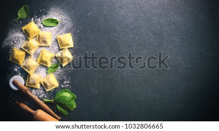 Ravioli with spinach and ricotta on dark background, top view Royalty-Free Stock Photo #1032806665
