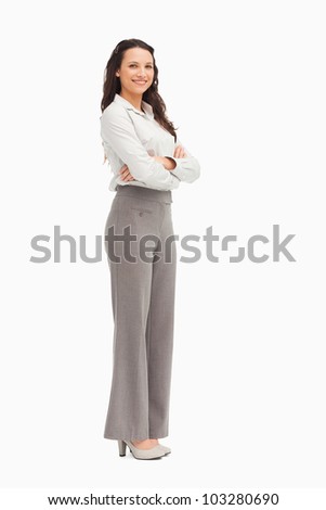 Portrait of a smiling employee with folded arms against white background