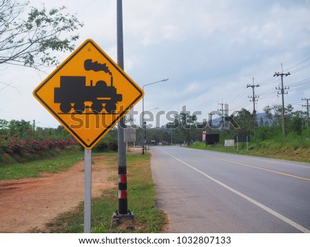 Railway crossing without gate warning sign panel on the road, Traffic sign for let's slow down the car because there is a train in front of the street