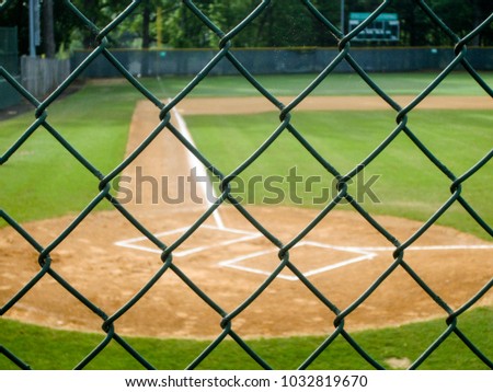 Blurred baseball field viewed through fence