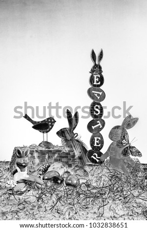 Happy Easter - a party and a holiday for the whole family. Motif with easter symbols, colorful eggs, butterflies, rabbits of wood and metal, grass and birds. Concept: Easter and holiday