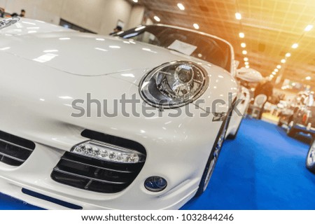 Close up of a white sport luxury car in a showroom