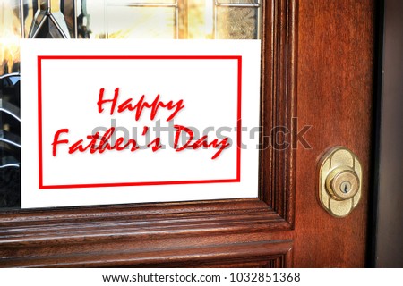 Happy Fathers Day sign on front door of home.