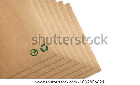 Eco packaging isolated on white background. Recycling paper bag brown shopping, that do not cause harm to the environment. Recycling and ecology sign. Ecologic craft package. Royalty-Free Stock Photo #1032856621