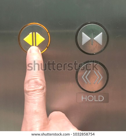 A man using the elevator by pressing open button