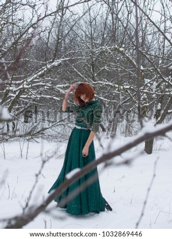 beautiful redhead girl in winter garden
