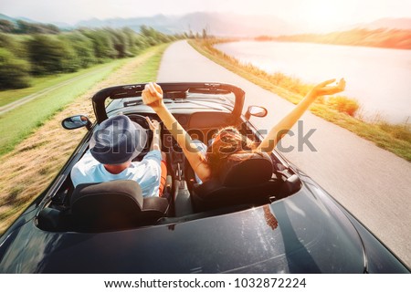 Couple in love ride in cabriolet car Royalty-Free Stock Photo #1032872224