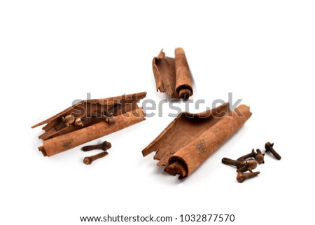 Cinnamon and cloves stock images. Cinnamon and clove isolated on white background. Aromatic spice collection