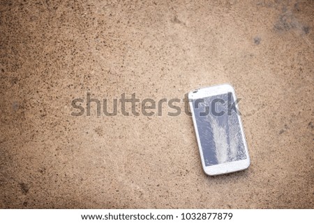Top view of broken mobile phone drop on cement floor with copy space for desing, High Contrast, Shallow Depth of Field, vintage tone.