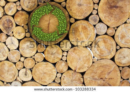 Stacked Logs with recycle symbol, concept Royalty-Free Stock Photo #103288334