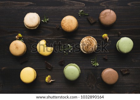 Sweet background. Delicious macaroons on the wooden table, top view.