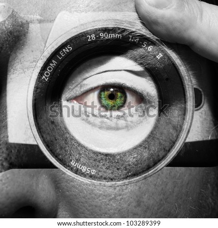 Camera painted on male face with green eyes