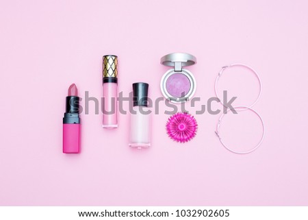 Cosmetic pink flowers on a pink background