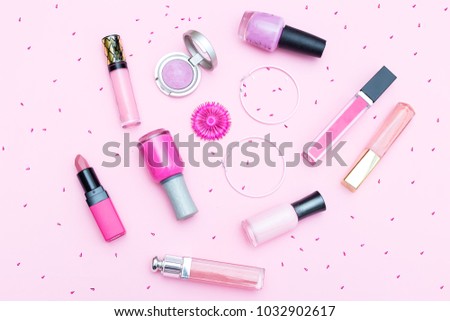 Cosmetic pink flowers on a pink background