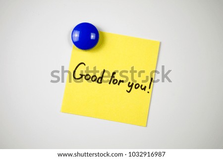 yellow sticker inscription Good for you! attached  blue magnet  white fridge. close-up
