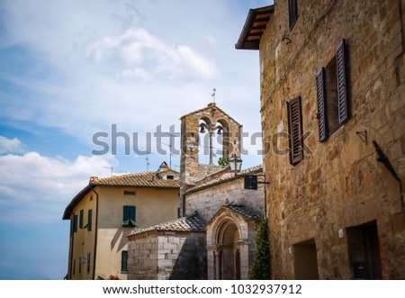 Ancient bell and tower in medieval church, countryside Tuscany, made from brick, Sienna, Italy