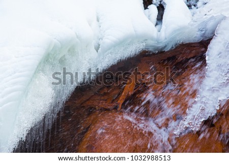 Cesis, Latvia. Red rock waterfall and ice at Latvia. Travel photo. 2018