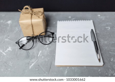 a note with a gift lie on the table, a concept of a congratulatory letter