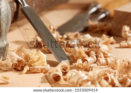 DIY concept. Woodworking and crafts tools. Carpentry hand tools on a workbench. Chisels, hammer, measuring tools.  Wooden parts, planks and stocks. Wooden background. 