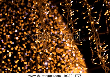 New Year lights abstract photo. Blurred lights on background with Bokeh Effect. Night shot of Christmas garland.
