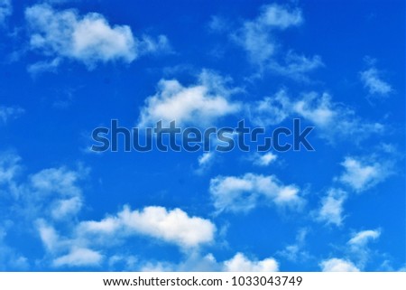 Bright sky with soft fluffy clouds, nature background.