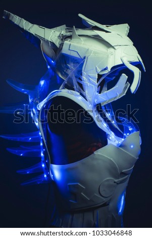 blue corset made by hand with plastic pieces and blue colored LEDs. robot of the future with space and futuristic helmet