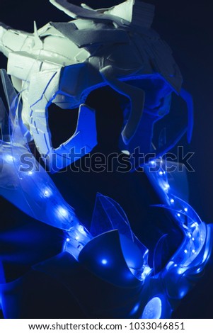 Robotic, blue corset made by hand with plastic pieces and blue colored LEDs. robot of the future with space and futuristic helmet
