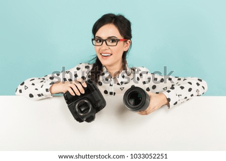 Young woman with camera and lens