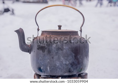 Kettle on the fire Russian samovar for tea, wood, street food